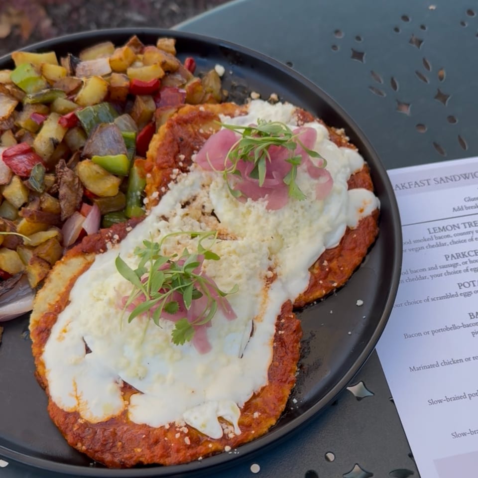 Max & Louie's breakfast plate with huevos rancheros and a side of roasted potatoes and peppers.